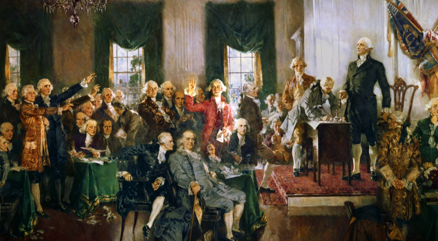 Un cadro da convención constitucional dos Estados Unidos cun home que ergue a man no centro.